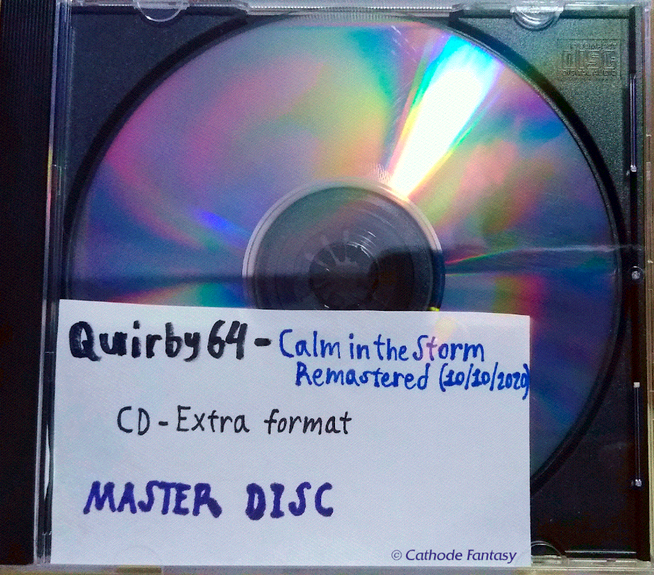 Close-up of the visible master disc authored for Quirby64 - Calm in the Storm Remastered inside a case. A small paper label inside has in handwriting, apart from the project name; (10/10/2020)  CD-Extra Format  MASTER DISC.